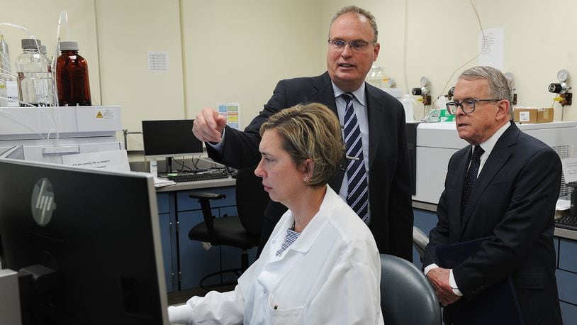 Montgomery County Coroner Dr. Kent Harshbarger, left, shows  Ohio Governor Mike DeWine around the Miami Valley Regional Crime Lab, Monday May 9, 2022. The Governor visited the lab to discuss the new Ohio Crime Lab efficiency program that was developed to help eliminate-processing backlogs and increase the speed at which criminal evidence is analyzed in certified crime laboratories across the state. MARSHALL GORBY\STAFF
