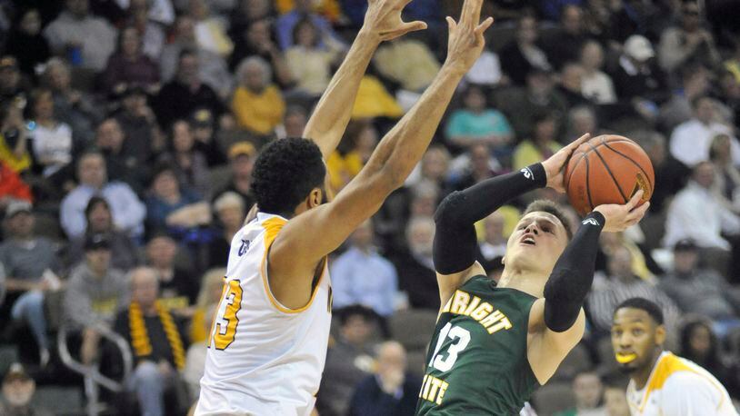 Wright State junior guard Grant Benzinger puts up a shot against Northern Kentucky’s Brennan Gillis during Tuesday night’s game at the BB&T Arena. JAY MORRISON/STAFF PHOTO