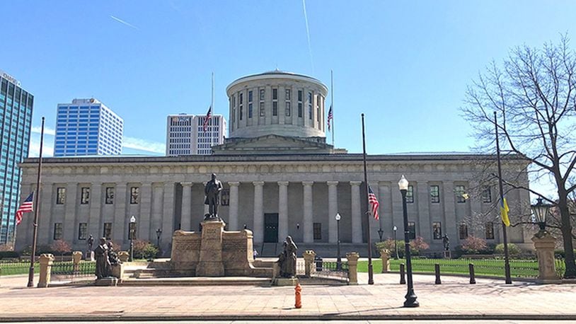 Flags fly at half staff in front of the Ohio Statehouse.