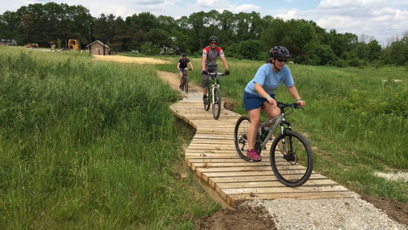 Three MetroParks employees try out the new Hilltop Flow trail at Huffman MetroPark’s mountain biking facility.
