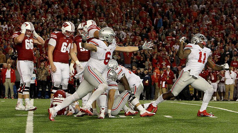 MADISON, WI - OCTOBER 15: The Ohio State Buckeyes celebrate after sacking Alex Hornibrook #12 of the Wisconsin Badgers to end the game in overtime at Camp Randall Stadium on October 15, 2016 in Madison, Wisconsin. (Photo by Dylan Buell/Getty Images)