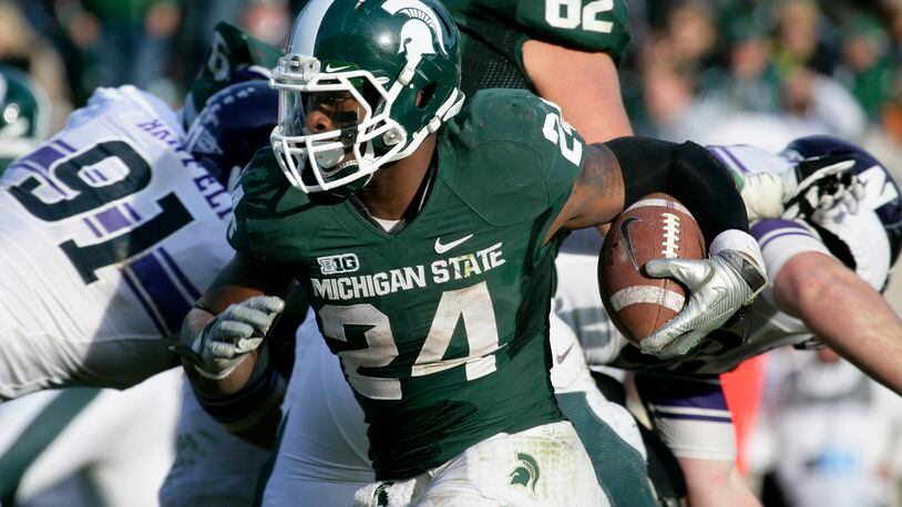 Michigan State's Le'Veon Bell (24) rushes during the fourth quarter of an NCAA college football game against Northwestern, Saturday, Nov. 17, 2012, in East Lansing, Mich. Northwestern won 23-20. (AP Photo/Al Goldis)