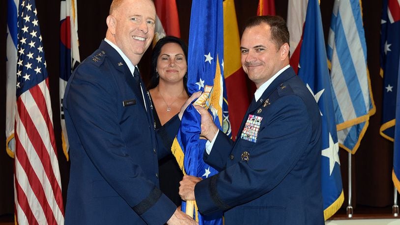 Lt. Gen. Robert McMurray (left), Air Force Lifecycle Management Center commander, passes the guidon to Brig. Gen. Sean Farrell as Farrell assumes command of the Air Force Security Assistance and Cooperation Directorate during a change of command ceremony at Wright-Patterson Air Force Base July 18. Farrell’s previous assignment prior to commanding AFSAC was as director, Strategic Plans, Programs and Requirements, Air Force Special Operations Command, Hurlburt Field, Florida. (U.S. Air Force photo/Al Bright)