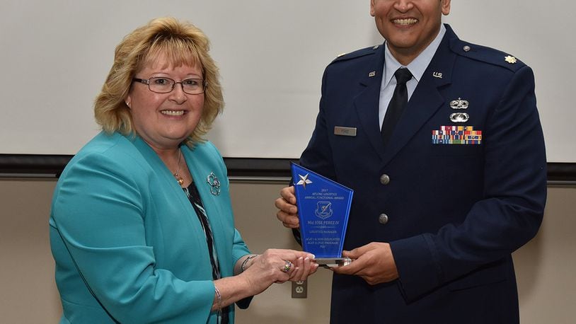 Cynthia Abbott, director of Logistics and Logistics Services, presents Maj. Jose Perez IV with a Logistics award. Perez was one of many individuals honored for outstanding achievement. (U.S. Air Force photo/Michelle Gigante)