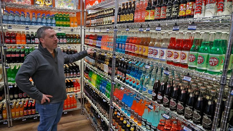 Chris Beers, owner of Grandpa Joe's Candy Shop, talks about the variety of soda flavors the new candy shop will carry including pickle soda and ketchup soda Monday, Nov. 14, 2022. BILL LACKEY/STAFF