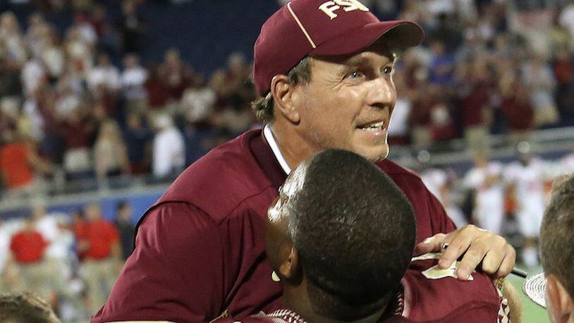 Florida State's Demarcus Walker picks up coach Jimbo Fisher in the final seconds as Florida State defeated Ole Miss on September 5, 2016, at Camping World Stadium, in Orlando, Fla. (Joe Burbank/Orlando Sentinel/TNS)