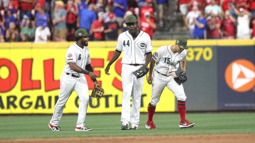 Reds outfielders Phillip Ervin, Aristides Aquino and Nick Senzel celebrate after a victory against the Cubs on Friday, Aug. 9, 2019, at Great American Ball Park in Cincinnati.