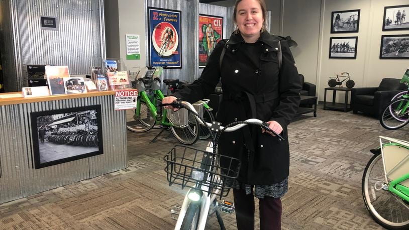 Laura Estandia, executive director of Bike Miami Valley, shows off one of Link Dayton Bike Share’s new electric bikes. eLink, the new electric-assisted bikes, will debut this spring. CORNELIUS FROLIK / STAFF