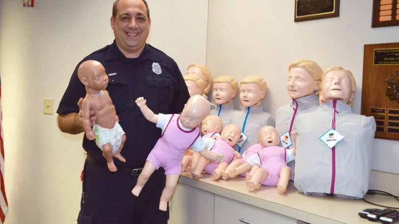 The Washington Twp. Fire Department has received new CPR Manikins that help students learn CPR by providing instant feedback on the quality of their compressions. Education Specialist Scott Henry is pictured holding the new and old infant manikins.