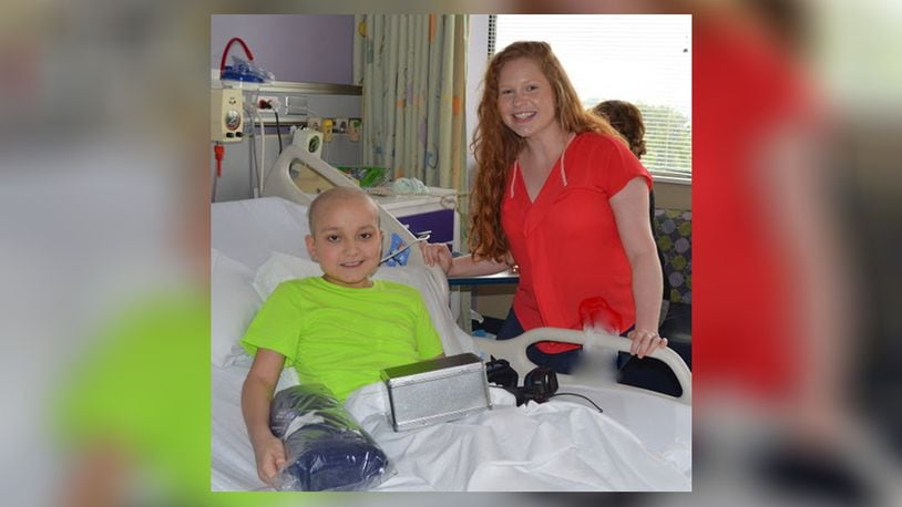 Pediatric oncology nurse Caitlin Hensley returned to Dayton Children’s Medical Center on July 6 as a volunteer. Here she chats with 10-year-old patient Colton Hefner and shares her own story of childhood cancer. CONTRIBUTED