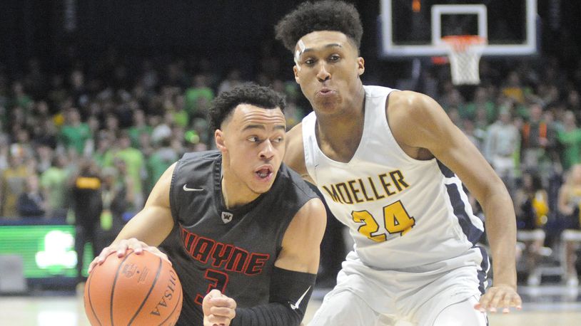 Wayne’s Darius Quisenberry (with ball) and Moeller’s Jeremiah Davenport, a Wright State recruit, were matched against each other. Moeller defeated Wayne 65-53 in a boys high school basketball D-I regional final at Xavier University Cintas Center in Cincinnati on Friday, March 16, 2018. MARC PENDLETON / STAFF