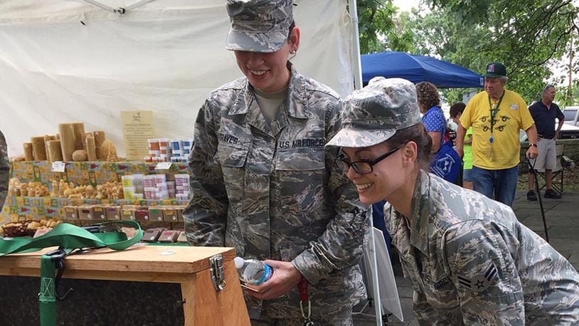 Airman 1st Class Hannah Graves (left), and Airman 1st Class Lillian Levy, both of the Bioenvironmental Sciences Engineer Squadron, 88th Medical Group, investigate a demonstration bee hive during the 3rd annual Pollinator Expo, Wright Memorial, Wright-Patterson Air Force Base June 19. (Skywrighter photo/Amy Rollins)
