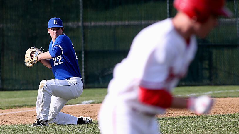Hamilton third baseman Eric Roberts stops the ball and gets Lakota West’s A.J. Petersen out at first during their game in West Chester Township on April 2, 2017. CONTRIBUTED PHOTO BY E.L. HUBBARD