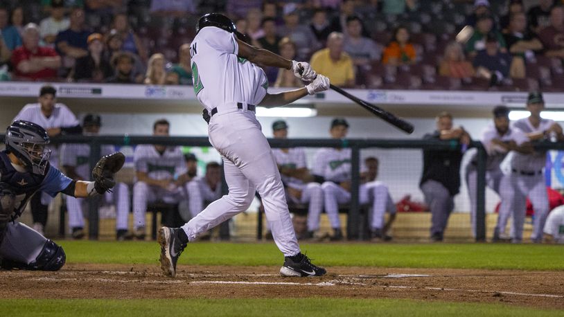 Dragons second baseman Ivan Johnson makes contact during the first inning Tuesday night in his first game in Dayton. He hit a two-run homer in the fourth inning for the Dragons' first hit of the game. Jeff Gilbert/CONTRIBUTED