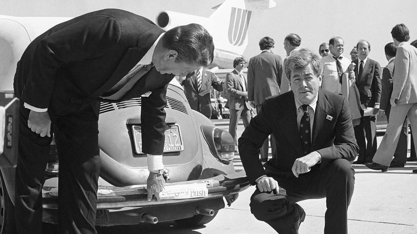 FILE - Republican presidential candidate Ronald Reagan, left, admires the bumper sticker on the car of Congressman Pete McCloskey as the congressman looks on, right, in San Jose, Calif., Sept. 25, 1980. Reagan was in the area on a campaign trip prior to leaving for more campaigning in Washington and Oregon. Former California Congressman McCloskey, who ran as a Republican challenging President Richard Nixon in 1972, has died at age 96. (AP Photo/Harrity, File)