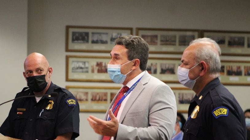 The city of Dayton is once again requiring city employees to wear masks inside. From left, Dayton Police Major Paul Saunders, John Musto with the city law department, and Police Chief Kamran Afzal participate in Wednesday's city commission meeting. Visitors were required to wear masks. CORNELIUS FROLIK / STAFF