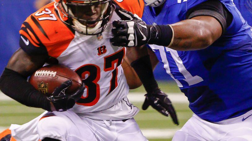 INDIANAPOLIS, IN - SEPTEMBER 3: Chris Lewis-Harris #37 of the Cincinnati Bengals runs the ball after an interception as Denzelle Good #71 of the Indianapolis Colts grabs for the tackle at Lucas Oil Stadium on September 3, 2015 in Indianapolis, Indiana. (Photo by Michael Hickey/Getty Images)