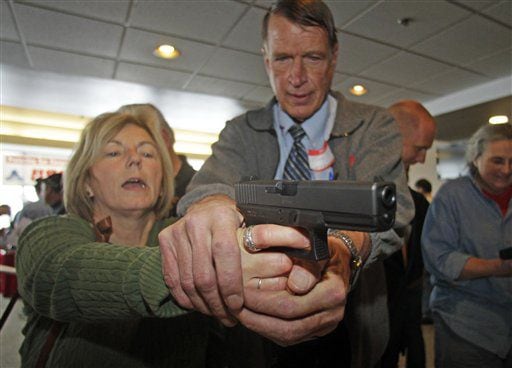 Glock from personal defense instructor Jim McCarthy during concealed weapons training for 200 Utah teachers Thursday, Dec. 27, 2012, in West Valley City, Utah.