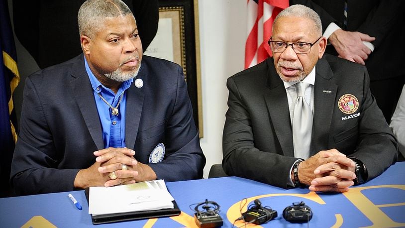 Dayton Unit NAACP President Derrick Foward, left, and Dayton Mayor Jeffrey Mims speak at a news conference Wednesday, Dec. 28, 2022, in which they and other community leaders spoke out against gun violence. MARSHALL GORBY \STAFF
