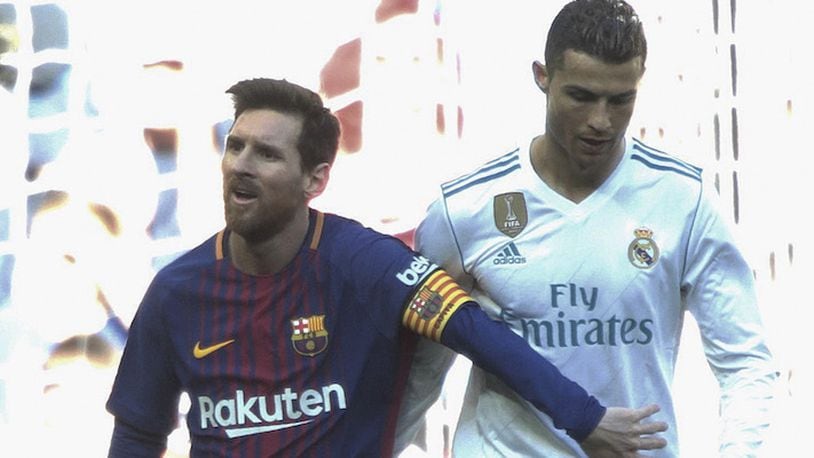 In a December 2017 file image, Real Madrid&apos;s Cristiano Ronaldo, right, and Barcelona&apos;s Lionel Messi walk side by side at the end of a Spanish La Liga match at the Santiago Bernabeu stadium in Madrid, Spain. (Juan Carlos Rojas/Xinhua/Zuma Press/TNS)