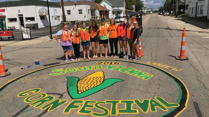 The candidates for the South Vienna Corn Festival queen contest paint the street ahead of the event. Contributed photo