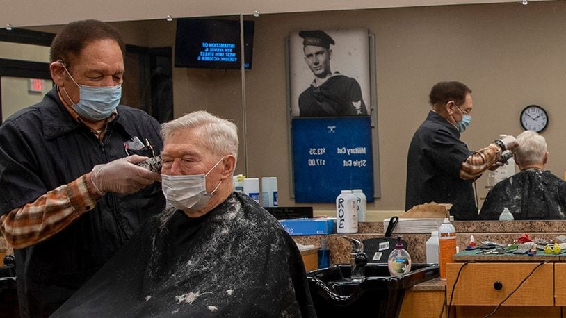 Richard Roe cuts the hair of a customer Feb. 5 at the Wright-Patterson Air Force Base Barber Shop. Meeting new people and being around the Air Force has kept him coming back to work for more than four decades, he says. U.S. AIR FORCE PHOTO/AIRMAN 1ST CLASS ALEXANDRIA FULTON