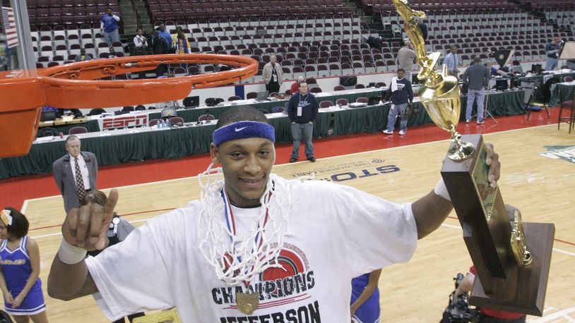 Adreian Payne, of Jefferson, has just cut a part of the basketball net and wrapped it around his neck all while holding the championship trophy. Dayton Jefferson beat Newark Catholic, in the Divison IV state championship game 59-52 in 2010. Payne scored 11 points and collected 9 rebounds.
