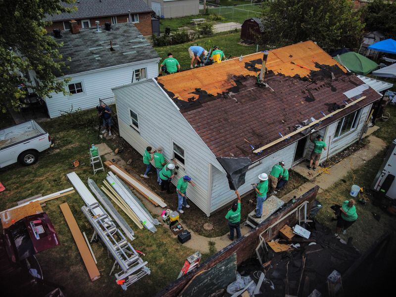 Recovery from the tornado was quick for some and slow for others.  Here, volunteers from Shiloh Church and corporate partners reroof a house on Oneida Avenue in Harrison Twp.  in September 2021, more than two years after the Memorial Day tornadoes.  JIM NOELKER/STAFF