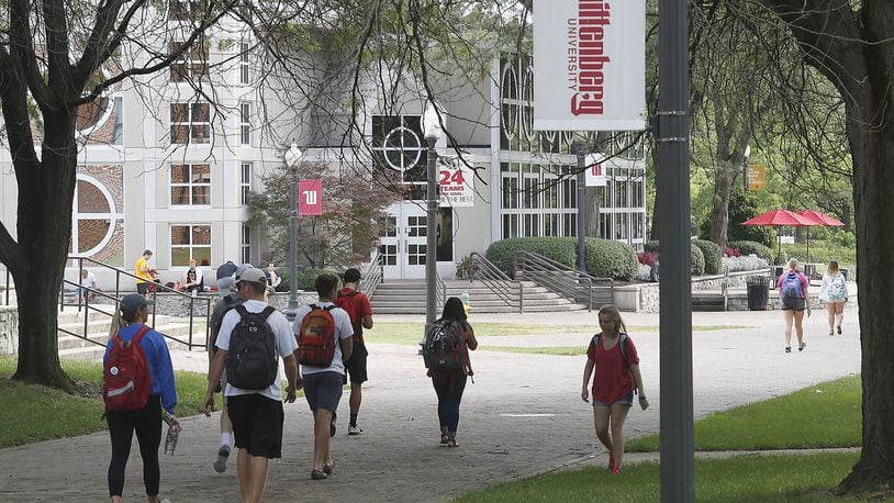 Students walk across campus at Wittenberg University Tuesday. Bill Lackey/Staff
