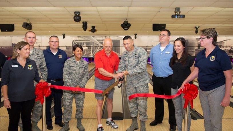 Col. Thomas P. Sherman, 88th Air Base Wing commander, and Mike Hellmann, Wednesday After Thoughts Bowling League secretary, cut the ceremonial ribbon for the Wright-Patterson Air Force Base Bowling Center Aug. 13. The center reopened following a $585,000 refurbishing. (U.S. Air Force photos/R.J. Oriez)