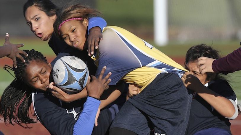 Rowe-Clark Shanya Jones is brought down by Pritzker's Taylor Jackson, left, during their rugby game at Altgeld Park in Chicago on November 7, 2015. Girls rugby has gained a stronghold in Chicago's Noble charter network of schools and is spreading quickly elsewhere in the U.S. (Nuccio DiNuzzo/Chicago Tribune/TNS)