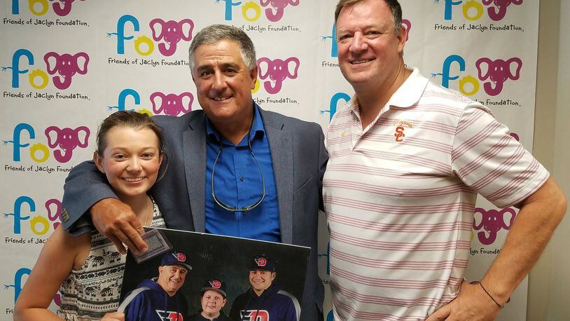 Jaclyn Murphy, Tony Vittorio (center) and Denis Murphy, founder of Friends of Jaclyn Foundation, show a photo of Vittorio, Cameron Neal and Kuris Duggan before Cameron’s death in 2015. CONTRIBUTED