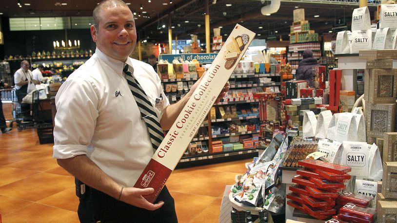Phil Issenmann, grocery and frozen manager for Dorothy Lane Market, selects unique items , including a yard of cookies, to add to store shelves. LISA POWELL / STAFF