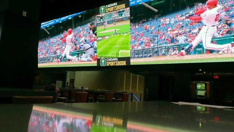 A screen at the sports book in the Tropicana casino in Atlantic City N.J. shows Juan Soto, then of the Washington Nationals, hitting a home run on May 12, 2022. On May 10, 2023, panelists at a sports betting conference in Secaucus N.J. predicted a quick rise in so-called microbetting, the type of rapid-fire bets made during a game on things like the result of the next at bat or even the next pitch of a baseball game. (AP Photo/Wayne Parry)