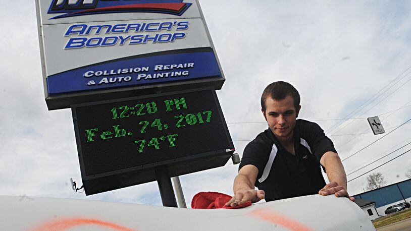 Joe Price, manager of the Maaco Bodyshop on Needmore Road was working outside on a unseasonably warm February day Friday. Temperatures soared to 76 degrees setting a record high for February. Staff photo/Marshall Gorby