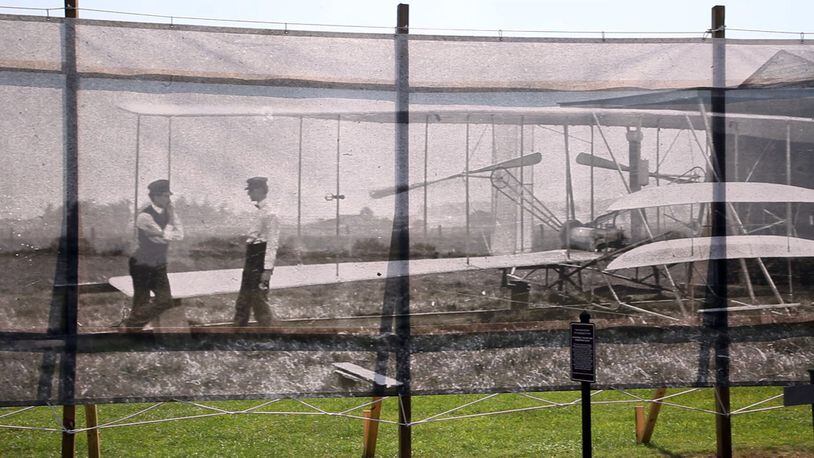 Dan Patterson, Artist in Residence with the Dayton Aviation Heritage National Historical Park had a 1904 image of the Wright Brothers on Huffman Prairie printed on mesh for display on the site of the original photo. TY GREENLEES / STAFF