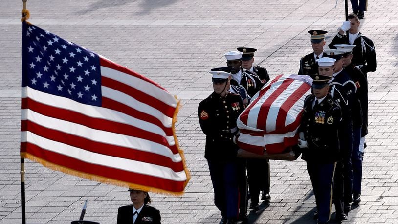 A military honor guard team carries the casket of President George H. W. Bush into the U.S. Capitol Dec. 3, 2018, in Washington, DC. A state funeral will be held over the next three days, beginning with him lying in state until Wednesday morning in the Rotunda of the Capitol. (Win McNamee/Getty Images)