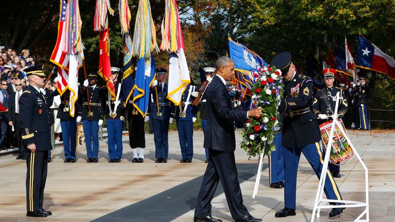 President Barack Obama lays a wreath at the Tomb of the Unknowns, on Veterans Day, Friday, Nov. 11, 2016, at Arlington National Cemetery in Arlington, Va. At left is Maj. Gen. Bradley A. Becker, Commander of the U.S. Army Military District of Washington. (AP Photo/Pablo Martinez Monsivais)