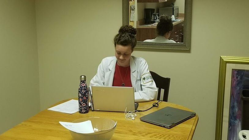 Dr. Lily White, pictured while she was still a student, meeting with patients via telemedicine through the Open Arms Health Clinic.  CONTRIBUTED