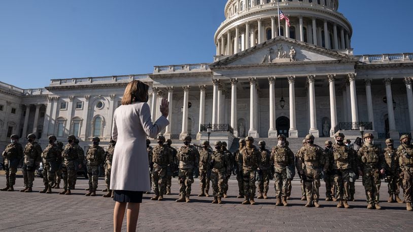 Speaker of the House Nancy Pelosi (D-Calif.) meets with National Guard troops outside the Capitol in Washington on Wednesday, Jan. 13, 2021. (Anna Moneymaker/The New York Times)