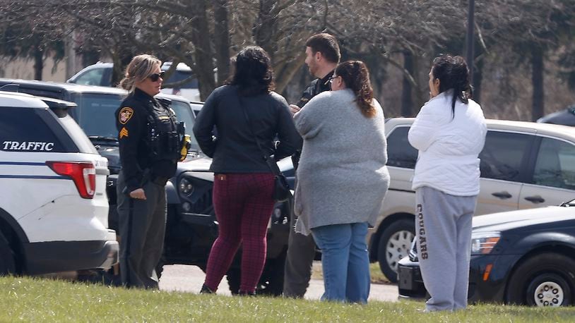 Worried Kenton Ridge High School parents talk to members of the Clark County Sheriff's Department after a false active shooter call was received Tuesday, March 22, 2023. BILL LACKEY/STAFF
