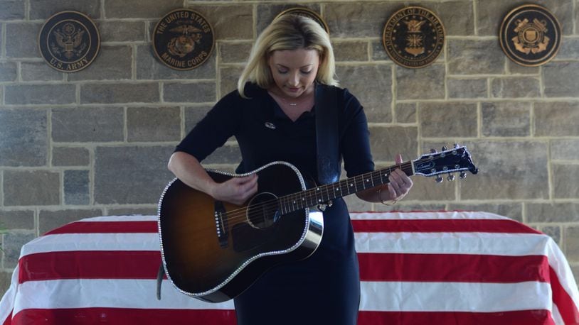 Country singer/songwriter Karen Waldrup honors World War II veteran Jim "Pee Wee" Martin with a performance of "Normandy" at his celebration of life and graveside service Wednesday, Sept. 21, 2022. Photo courtesy Ron Kaplan