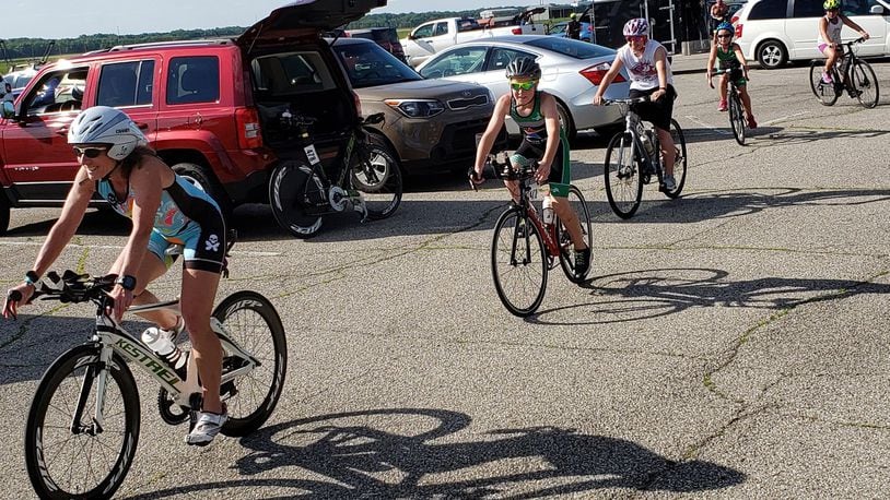 Coach Cheryl Chaney of Troy leads her team of young riders as they pedal through the Area A Tennis Club parking lot before the June 11 Blue Streak time trial at Wright-Patterson Air Force Base. (Courtesy photo/Chuck Smith)
