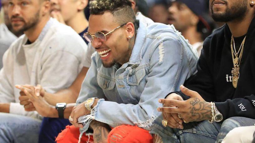 Recording artist Chris Brown attends a basketball game at Staples Center on August 13, 2017 in Los Angeles, California. Brown is another artists a women’s group wants Spotify to ban after the music streaming service banned R. Kelly songs from its playlists recently.
