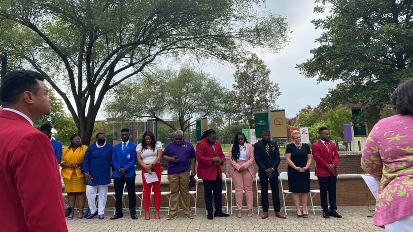 NPHC members and university administration stand as an innovation is read on Saturday to introduce the National Pan-Hellenic Council Memorial Plots to campus. Eileen McClory / Staff