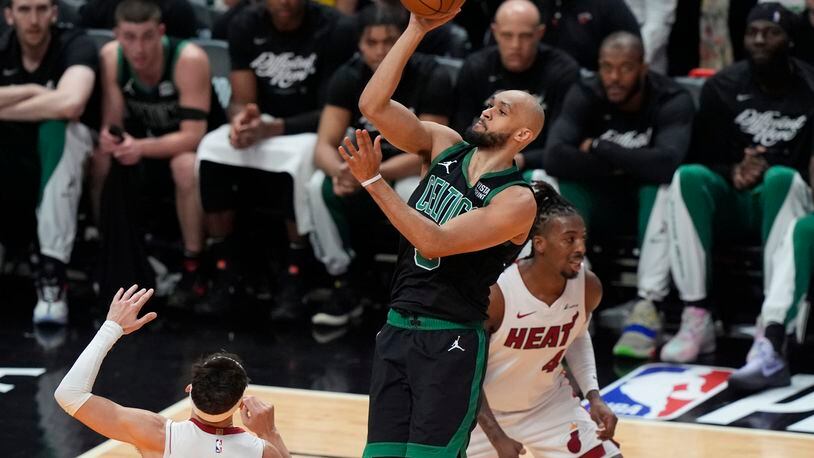 Boston Celtics guard Derrick White (9) scores over Miami Heat guard Tyler Herro (14) during the first half of Game 4 of an NBA basketball first-round game, Monday, April 29, 2024, in Miami. (AP Photo/Marta Lavandier)