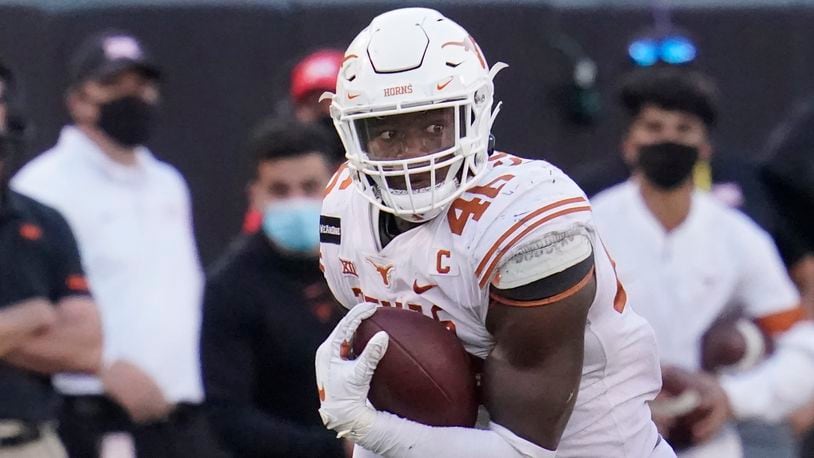 Texas outside linebacker Joseph Ossai carries during an NCAA college football game against Oklahoma State, in Stillwater, Okla., Saturday, Oct. 31, 2020. Ossai was selected to The Associated Press All-America first-team offense, Monday, Dec. 28, 2020. (AP Photo/Sue Ogrocki)
