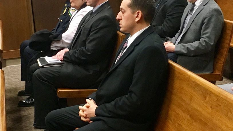 Former Kettering police detective Ryan Meno waits in court before he was sentenced for theft of drugs, theft in office and obstruction of justice after he admitted to stealing pain pills from an elderly woman’s home.