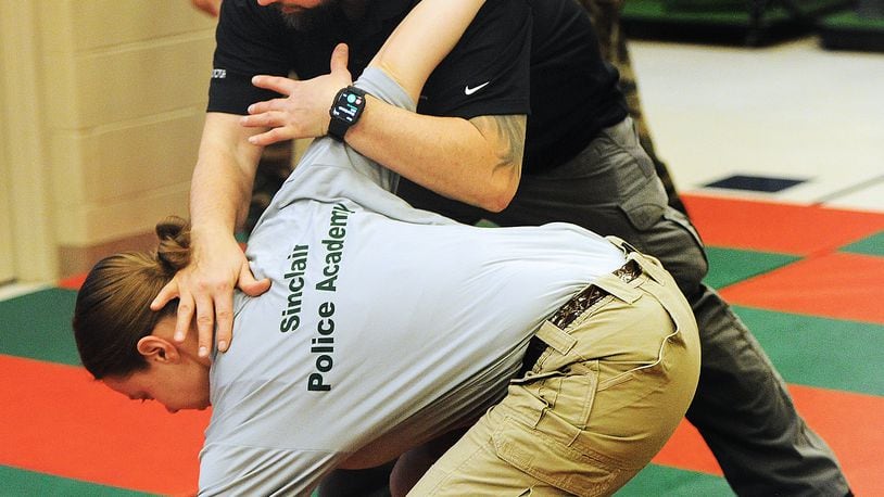 Instructor JP Kotronis demonstrates a takedown on reporter London Bishop. MARSHALL GORBY\STAFF