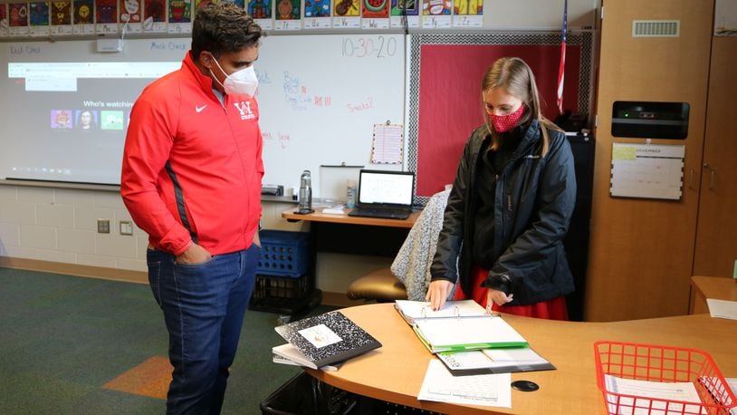 Storm Smith, first-grade teacher at Wright Brothers Elementary, shares her hybrid lesson plans with Superintendent Mario Basora.